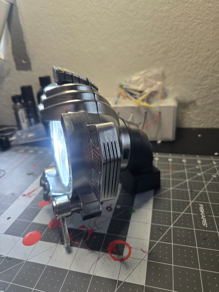 Silver Max prop side profile on a cutting mat with the front lens illuminated