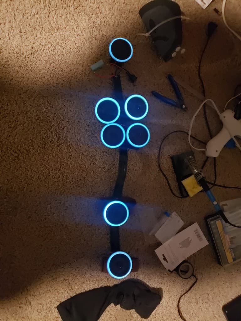 Early HoloDevice prototypes with cyan LED rings laid out during bench testing