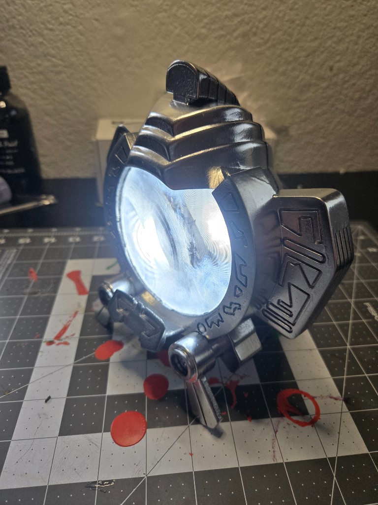 Built and painted MAX prop glowing on a workbench cutting mat