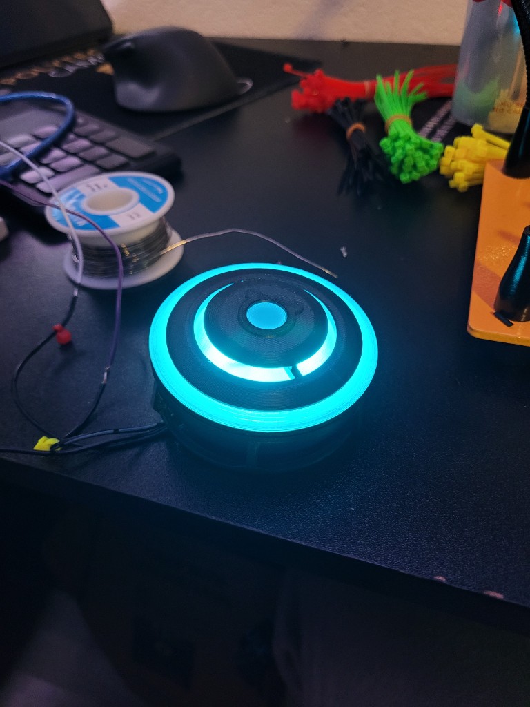 Built Mirage holo device glowing cyan on a prop maker workbench